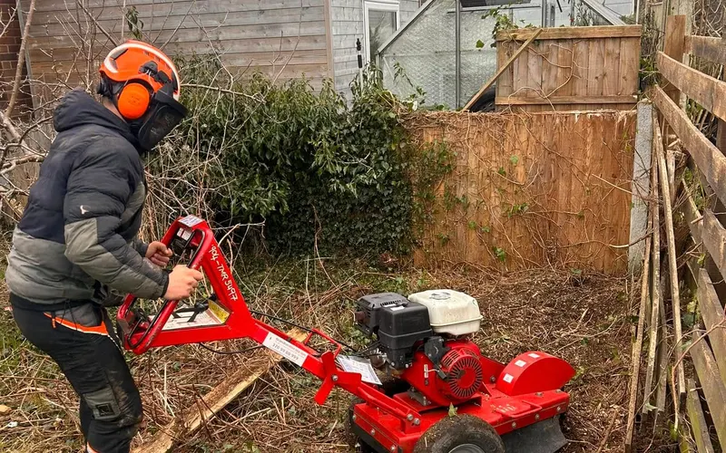 Stump grinder working a stump in a rear garden